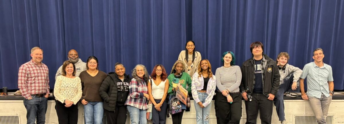 A large group of OhanaHC mentors and students standing together on a stage.