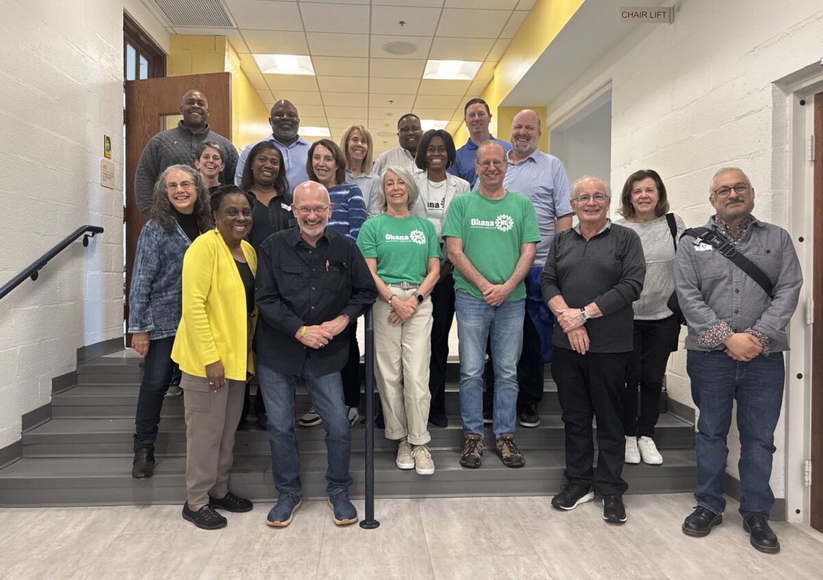 The OhanaHC Board of Directors and leadership team gathered together on a staircase.