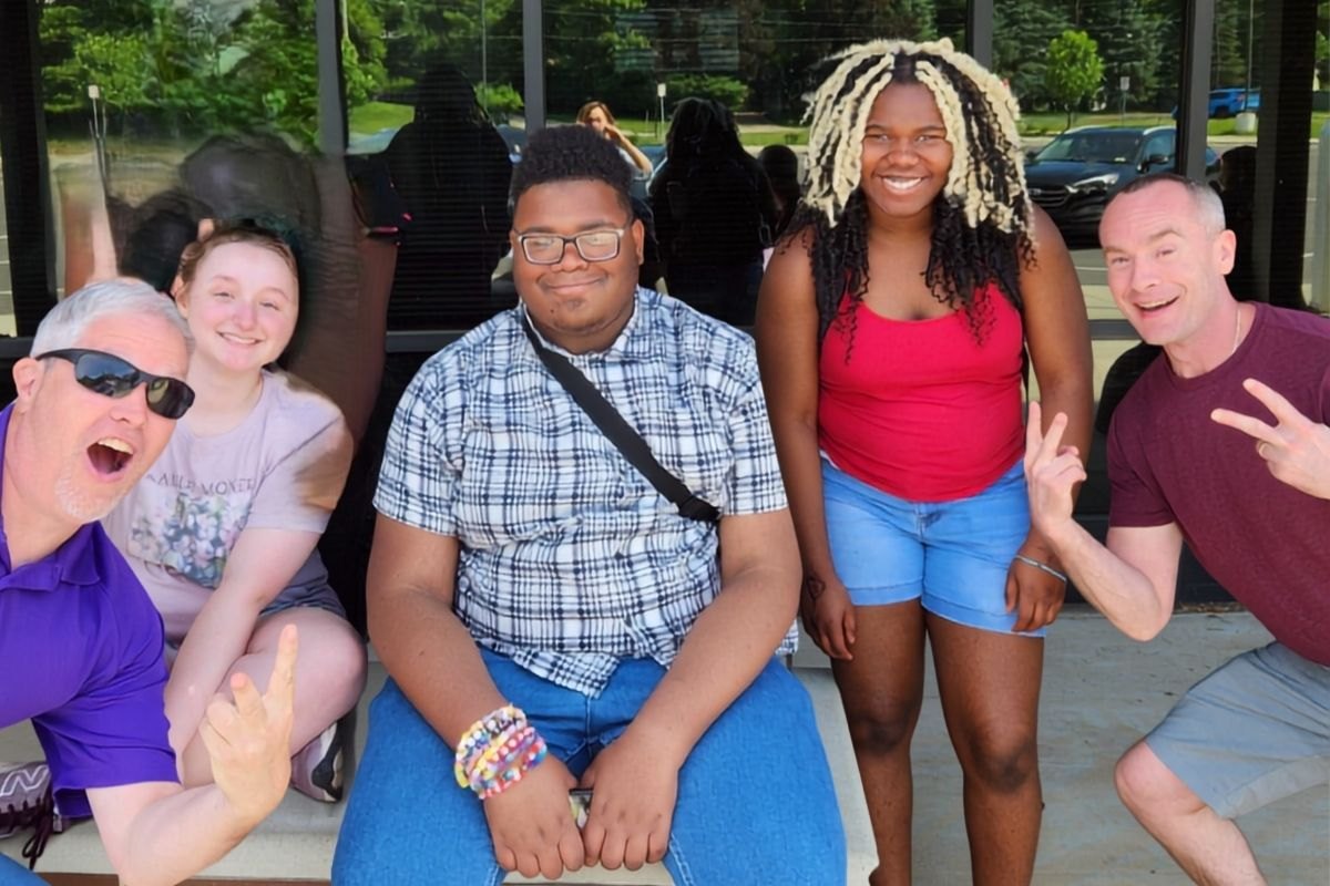 Three OhanaHC students and two mentors laughing together outside Hammond High School