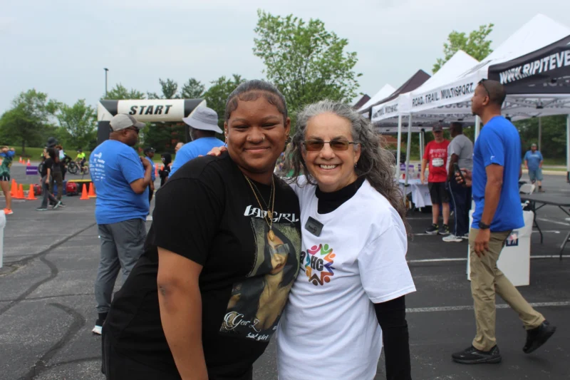 An OhanaHC student and her mentor, arm in arm and smiling at the OhanaHC 5K