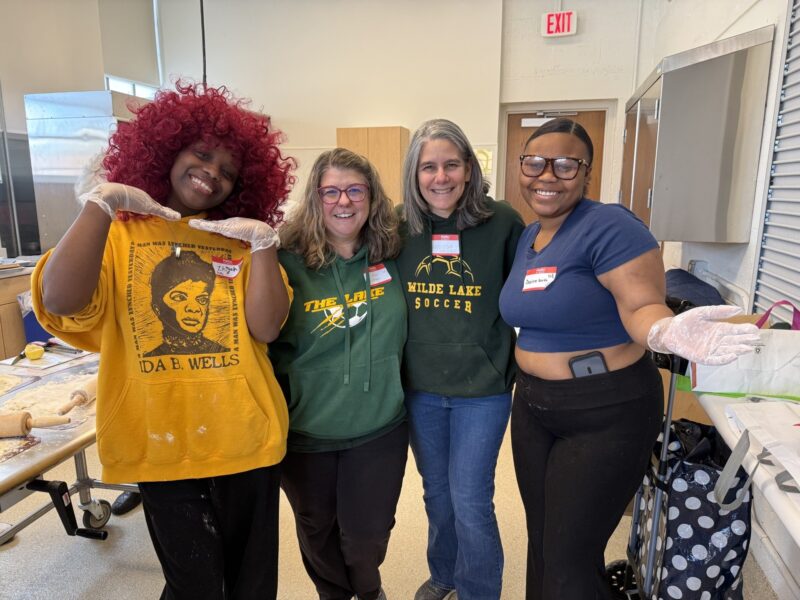 Four OhanaHC mentors and a student smiling together at game night