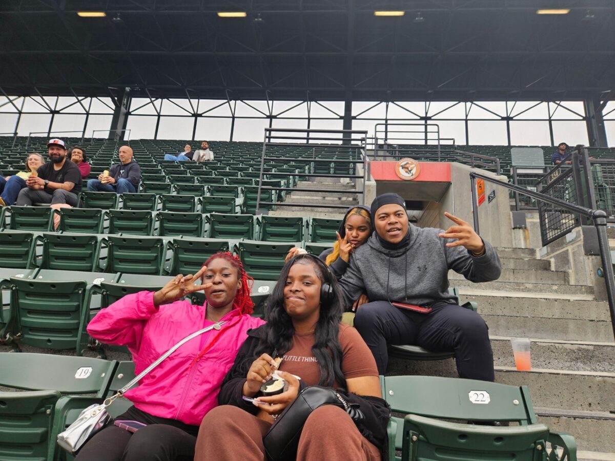 OhanaHC students and a mentor in the stands at an Orioles game.