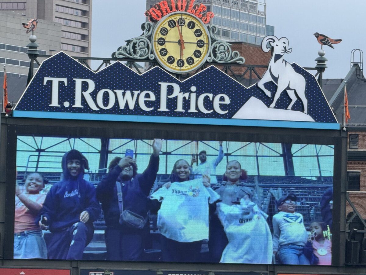 Pathfinders and their mentors cheering on the video board at an Orioles game at Camden Yards
