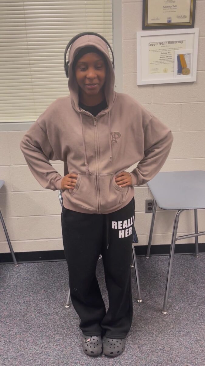An OhanaHC student smiling in a classroom as she talks about seeing the good in people