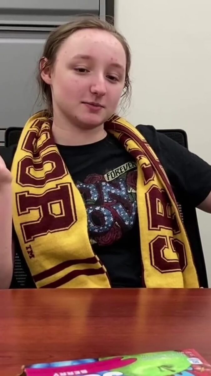 A student mid sentence, the frame the film opens on