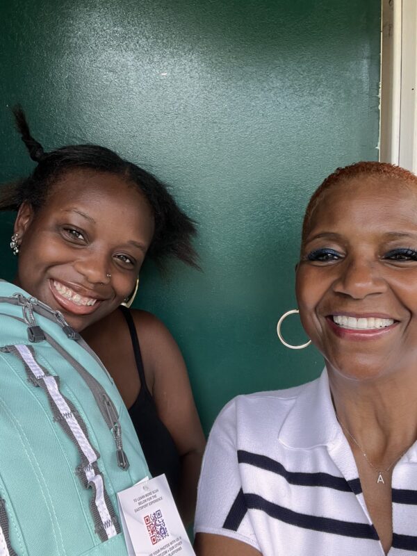 An OhanaHC mentor and her student cheek to cheek, both smiling
